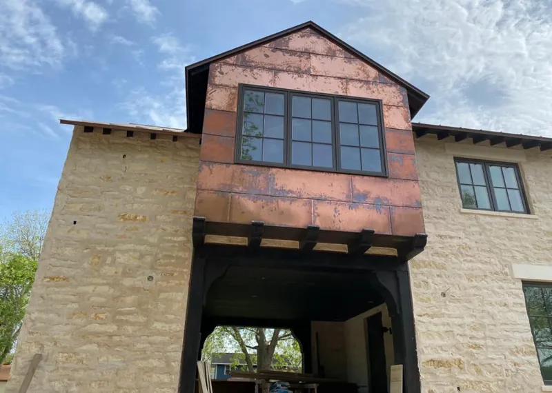 Copper metal panel facade on a stone building for Skylight Installation in Farmersville