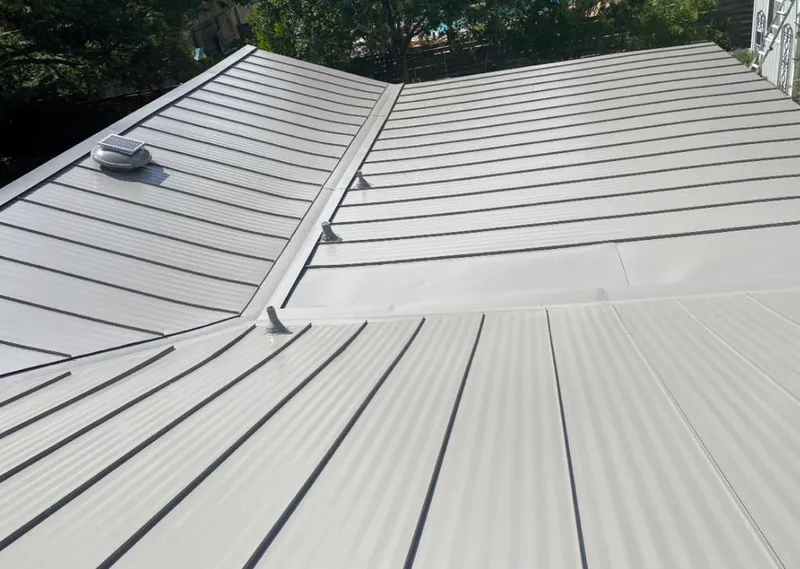 Solar attic fan installed on a metal roof for Roof Ventilation in Farmersville